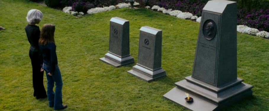 Storm and Kitty Pryde contemplate the gravestones of Jean Grey, Scott Summers, and Charles Xavier in 'X Men: The Last Stand'